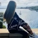 Model with long hair overlooking ocean