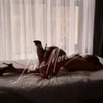 Luxury companion Chloe stretched on bed in Zurich suite