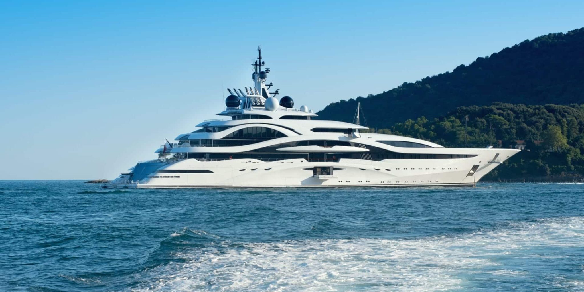 Huge luxury yacht cruising offshore