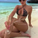 Luxury escort dubai in leopard bikini on beach