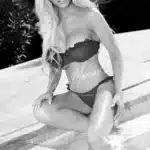 Glamorous bikini model by the pool
