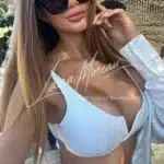 Busty Blonde Escort in White Bra