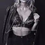Black and white portrait of a seductive London escort wearing lace bralette and leather jacket