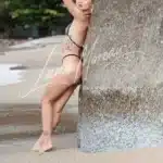 Elegant VIP escort arching her body in black lingerie – sensual Phuket beach shoot