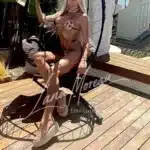 Chic model in bikini relaxing on a stylish beach chair in Mykonos
