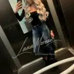 Blonde beauty in black top and jeans in elevator – casual luxury look