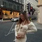 Fashionable model in cream dress