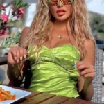 blonde vip escort in neon top