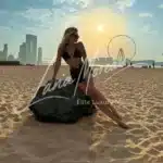 Blonde model in black beachwear