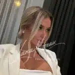 Headshot of Lisa in white evening attire with pearl jewelry – classy and graceful companion