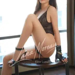Glamorous Tokyo escort posing in black lace lingerie and gloves